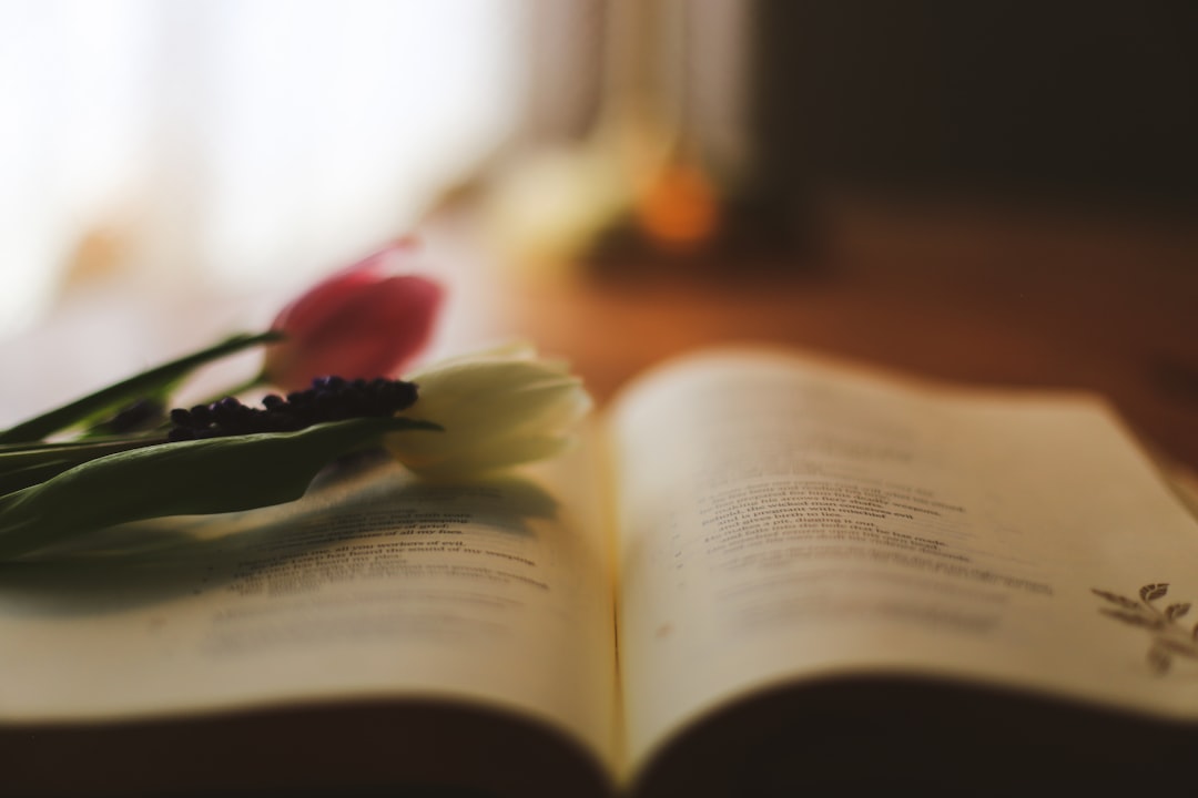 Tulips rest on an open book.