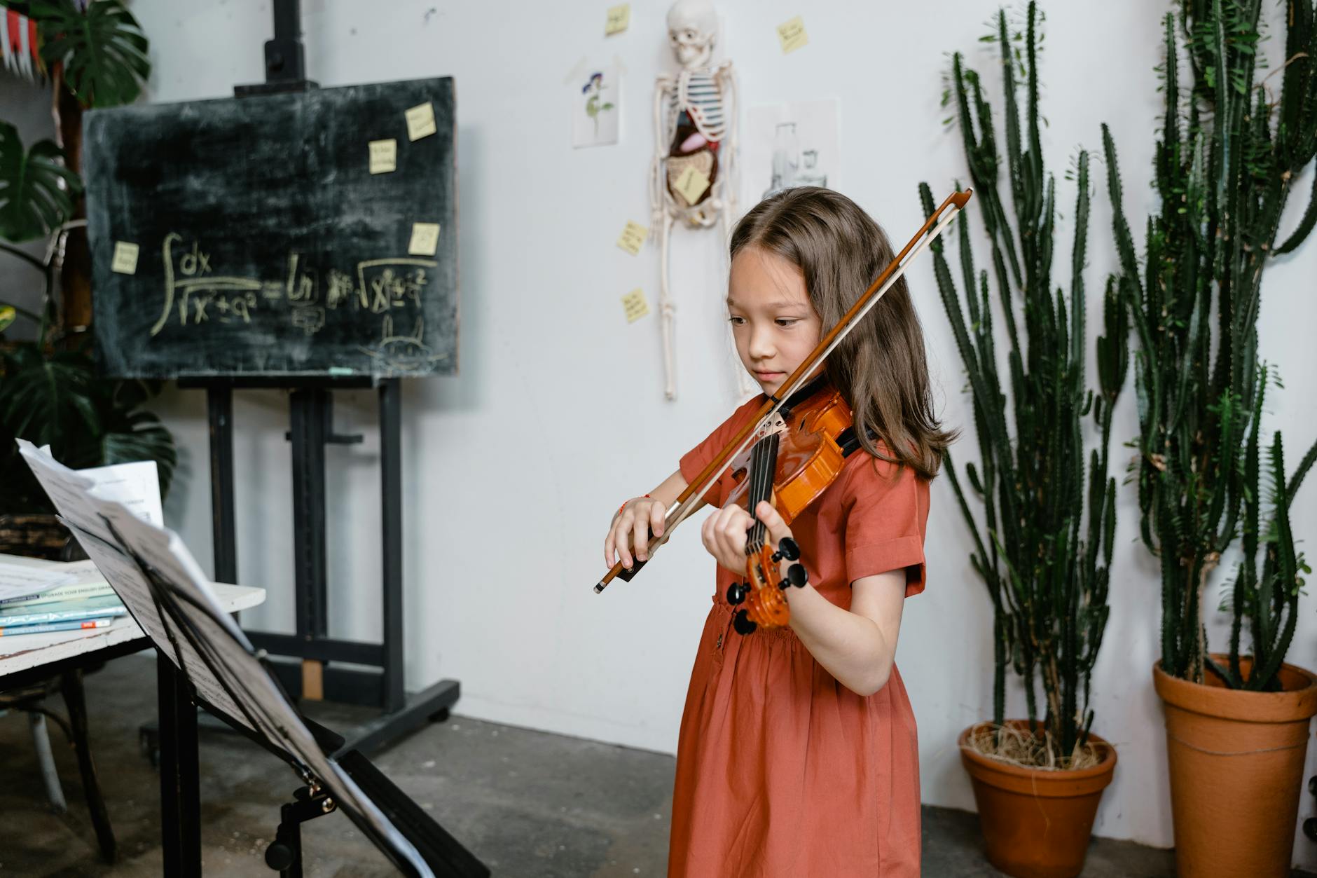 Child playing violin indoors, surrounded by mathematical equations and plants.