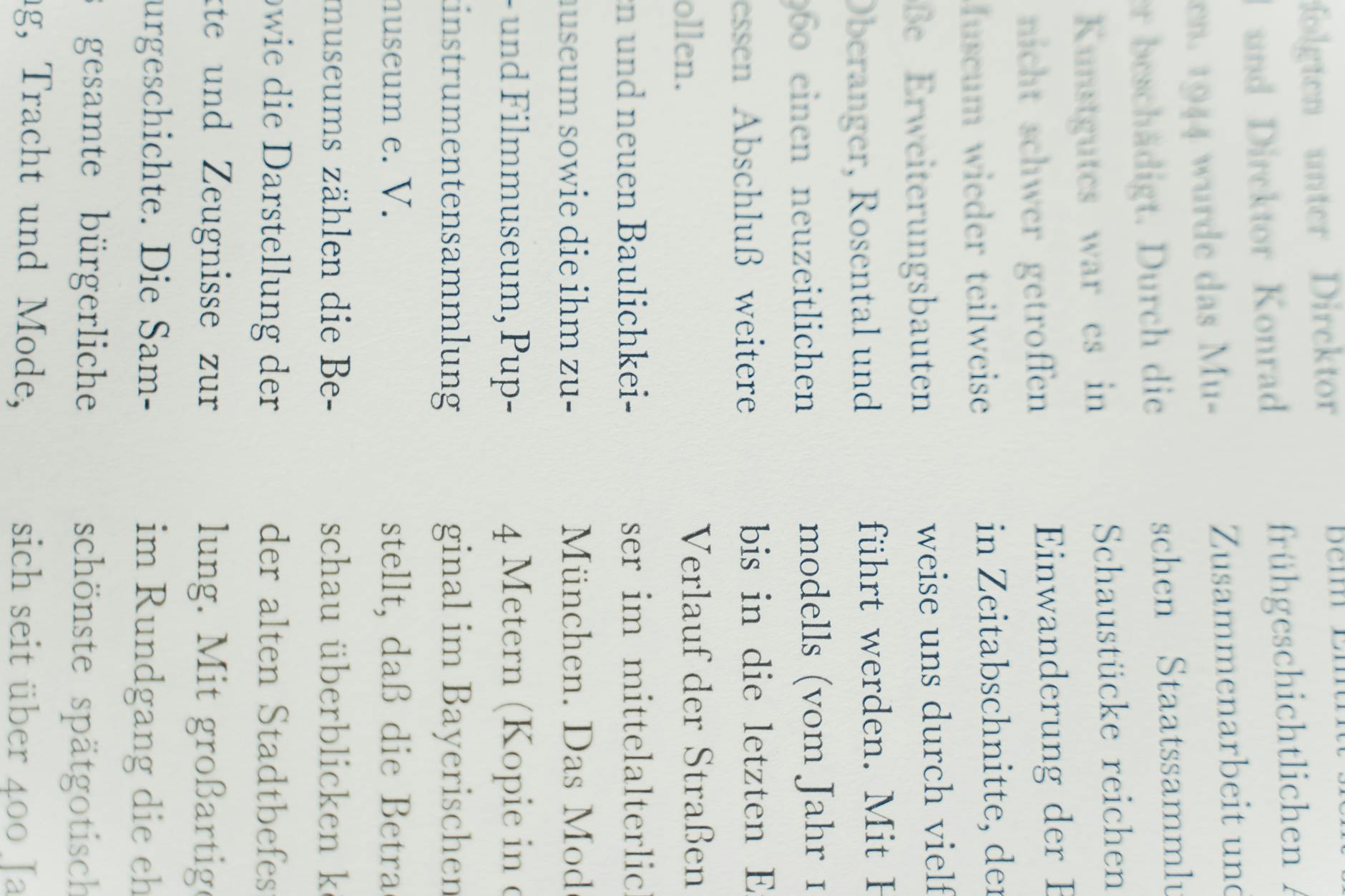 Detailed close-up of German text printed on white paper, focusing on typography.