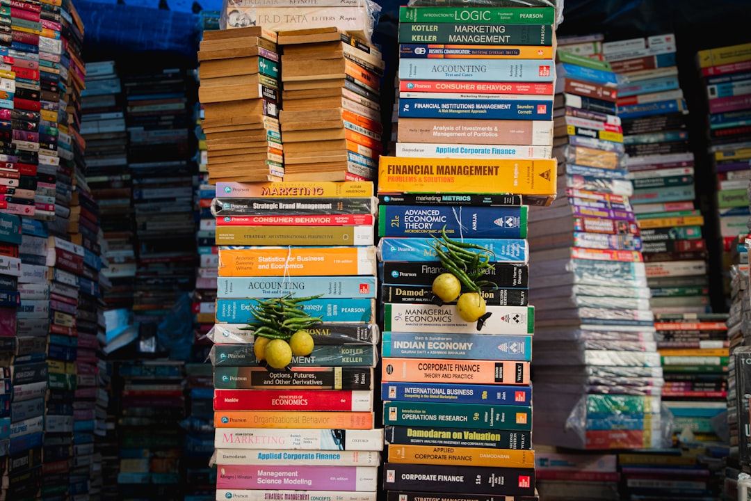 a stack of books with a bunch of fruit on top of them