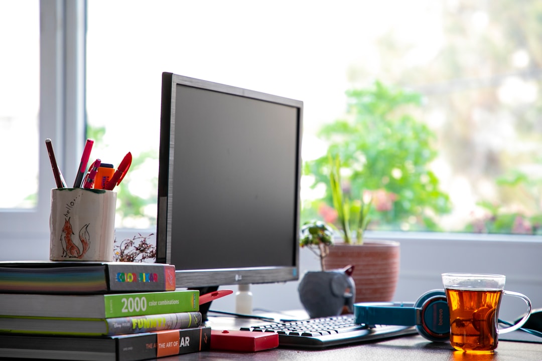 black flat screen computer monitor on white desk